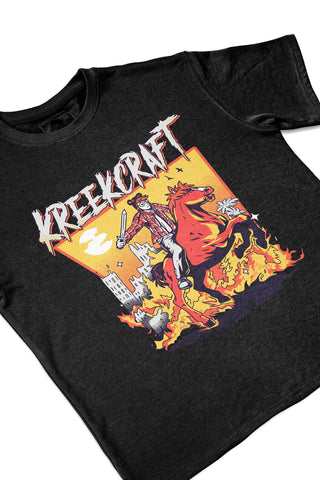 KreekCraft black tee with KreekCraft riding a horse in a burning city artwork on the entire front, in close-up.