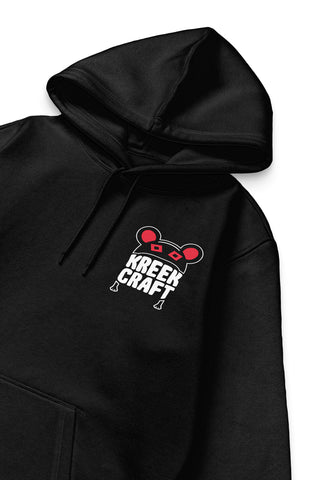 KreekCraft black hoodie with the KreekCraft logo in red and white on the left front chest, in close-up.